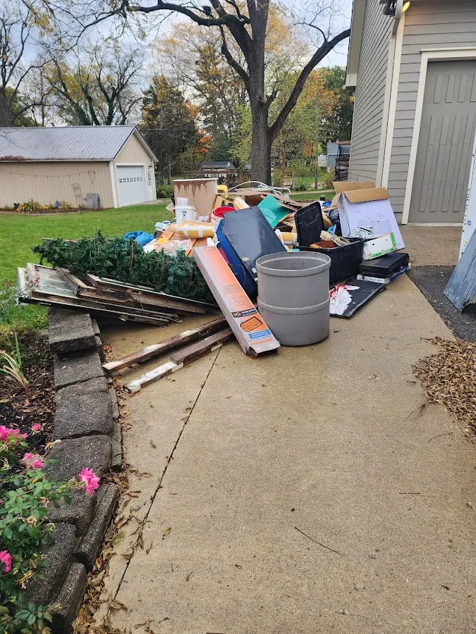 Dumpster being loaded with debris for 10 Yard Dumpster Rental in Tioga